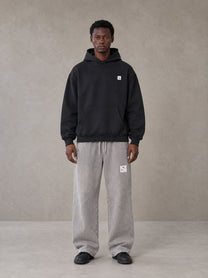 Model wearing SM Sig. High Neck Fleece Hoodie in Midnight Black, front view.