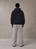 Model wearing SM Sig. High Neck Fleece Hoodie in Midnight Black, rear view.