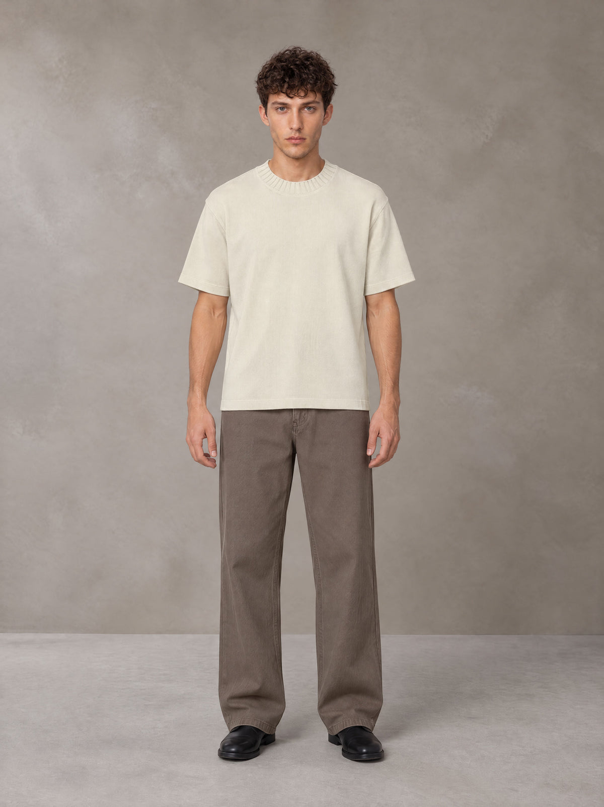 Model wearing SM Sig. Knitted Round Neck T-shirt in Neutral Heather, front view.