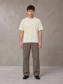 Model wearing SM Sig. Knitted Round Neck T-shirt in Neutral Heather, front view.