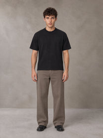Model wearing SM Sig. Knitted Round Neck T-shirt in Midnight Black, front view.