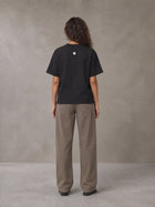 Model wearing SM Sig. Knitted Round Neck T-shirt in Midnight Black, rear view.