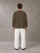 Model wearing SM Sig. Long Sleeve T-shirt in Brown, rear view.