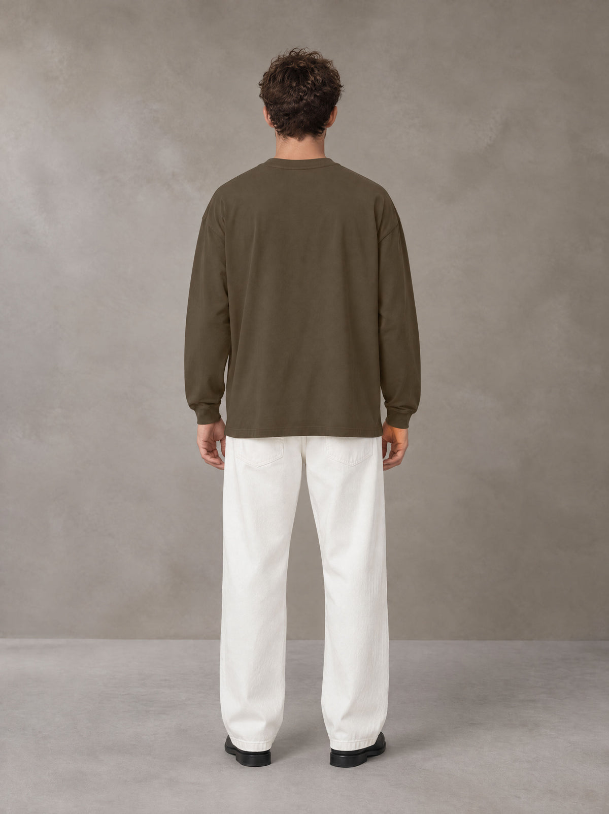 Model wearing SM Sig. Long Sleeve T-shirt in Brown, rear view.