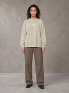 Model wearing SM Sig. Long Sleeve T-shirt in Fine Sand, front view.