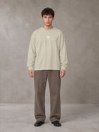 Model wearing SM Sig. Long Sleeve T-shirt in Fine Sand, front view.