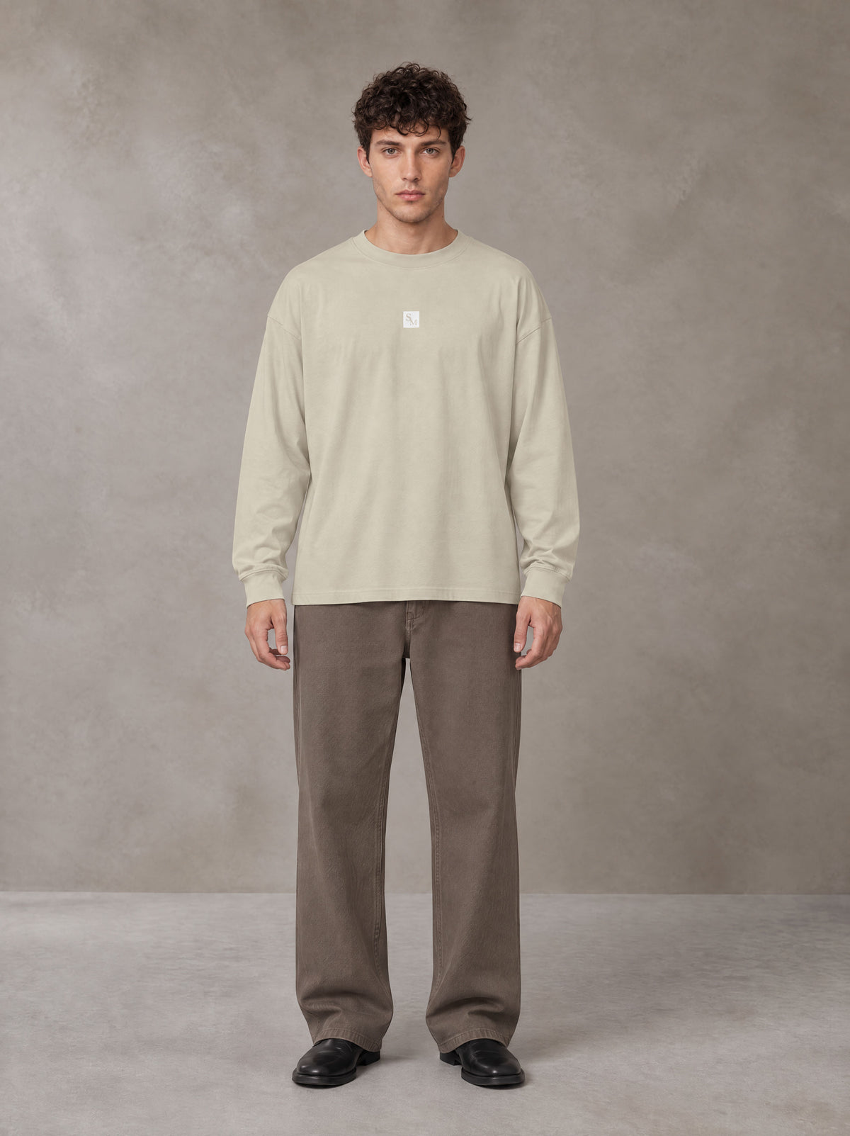 Model wearing SM Sig. Long Sleeve T-shirt in Fine Sand, front view.