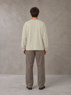Model wearing SM Sig. Long Sleeve T-shirt in Fine Sand, rear view.