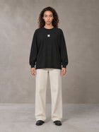 Model wearing SM Sig. Long Sleeve T-shirt in Midnight Black, front view.
