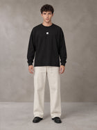 Model wearing SM Sig. Long Sleeve T-shirt in Midnight Black, front view.