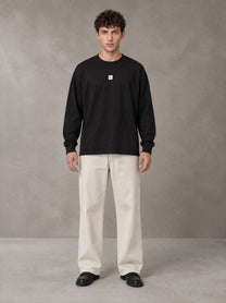 Model wearing SM Sig. Long Sleeve T-shirt in Midnight Black, front view.
