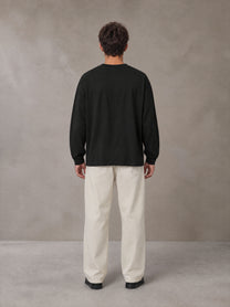 Model wearing SM Sig. Long Sleeve T-shirt in Midnight Black, rear view.