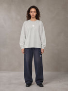 Model wearing SM Sig. Long Sleeve T-shirt in Pure Grey, front view.