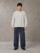 Model wearing SM Sig. Long Sleeve T-shirt in Pure Grey, front view.