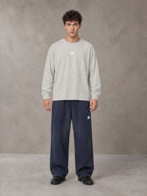 Model wearing SM Sig. Long Sleeve T-shirt in Pure Grey, front view.