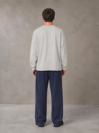 Model wearing SM Sig. Long Sleeve T-shirt in Pure Grey, rear view.