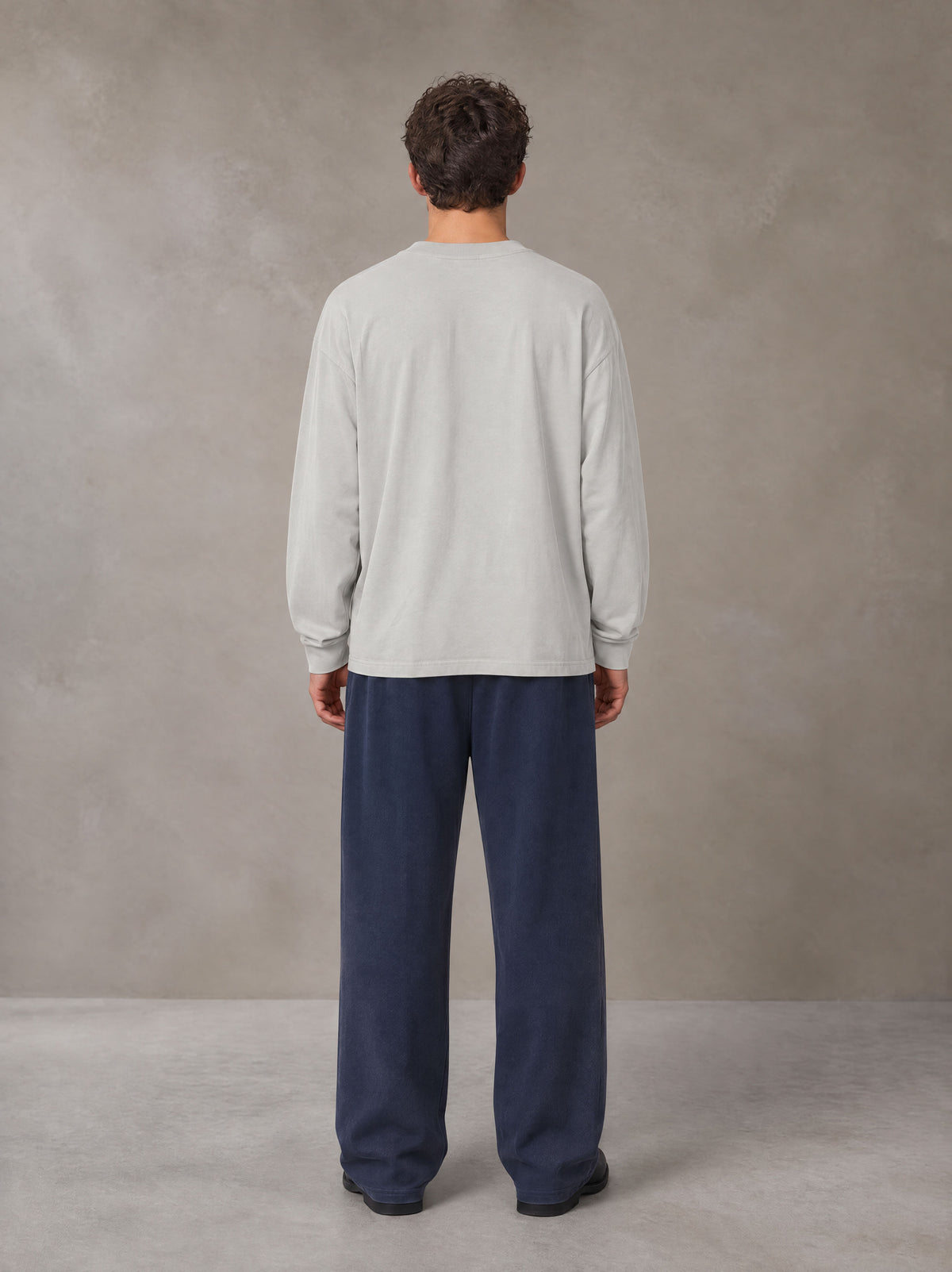 Model wearing SM Sig. Long Sleeve T-shirt in Pure Grey, rear view.