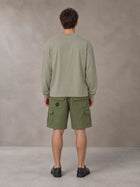 Model wearing SM Sig. Long Sleeve T-shirt in Stone Grey, rear view.