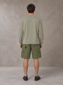 Model wearing SM Sig. Long Sleeve T-shirt in Stone Grey, rear view.