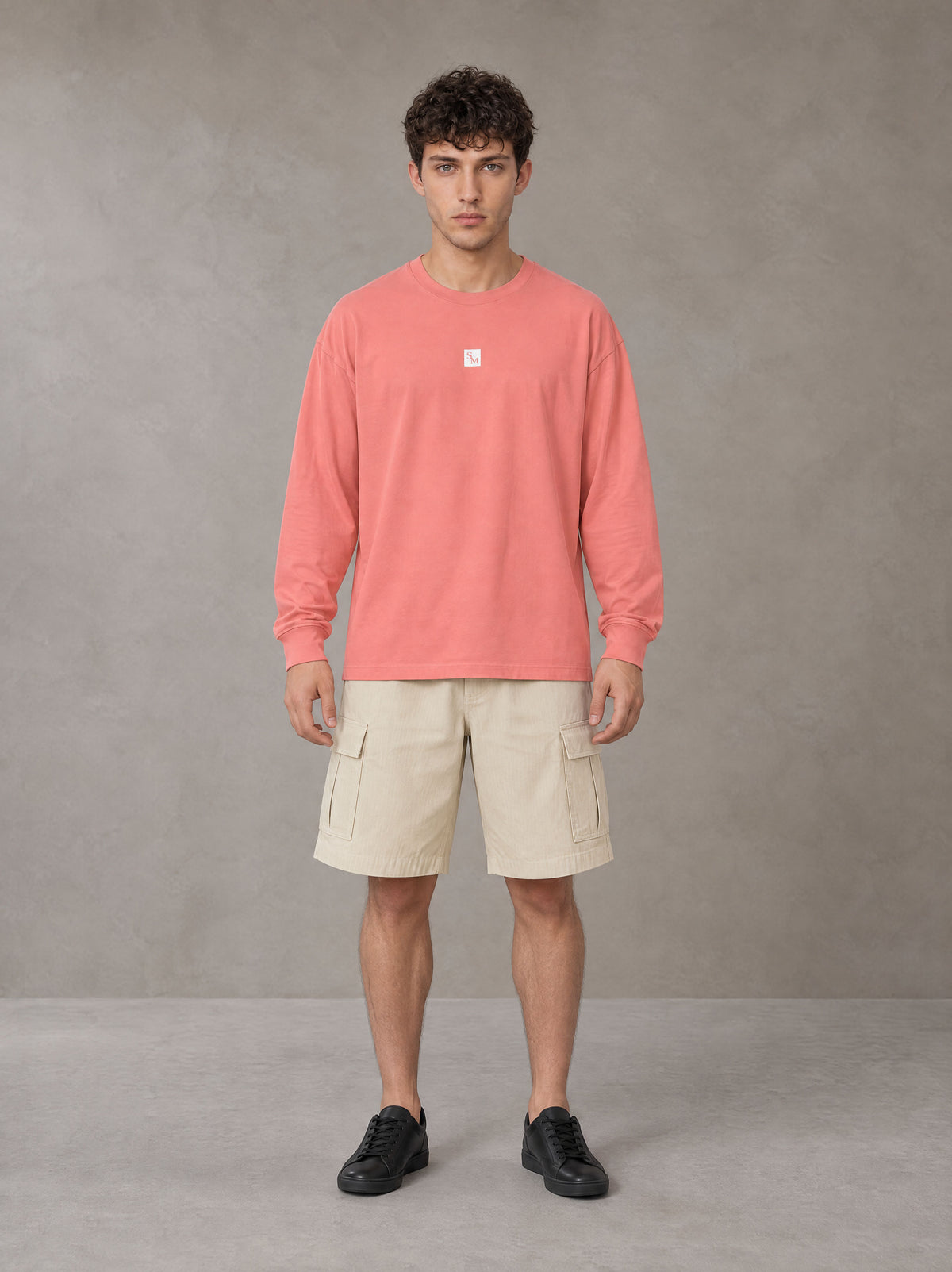 Model wearing SM Sig. Long Sleeve T-shirt in Watermelon Tint, front view.