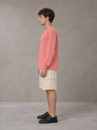 Model wearing SM Sig. Long Sleeve T-shirt in Watermelon Tint, side profile.