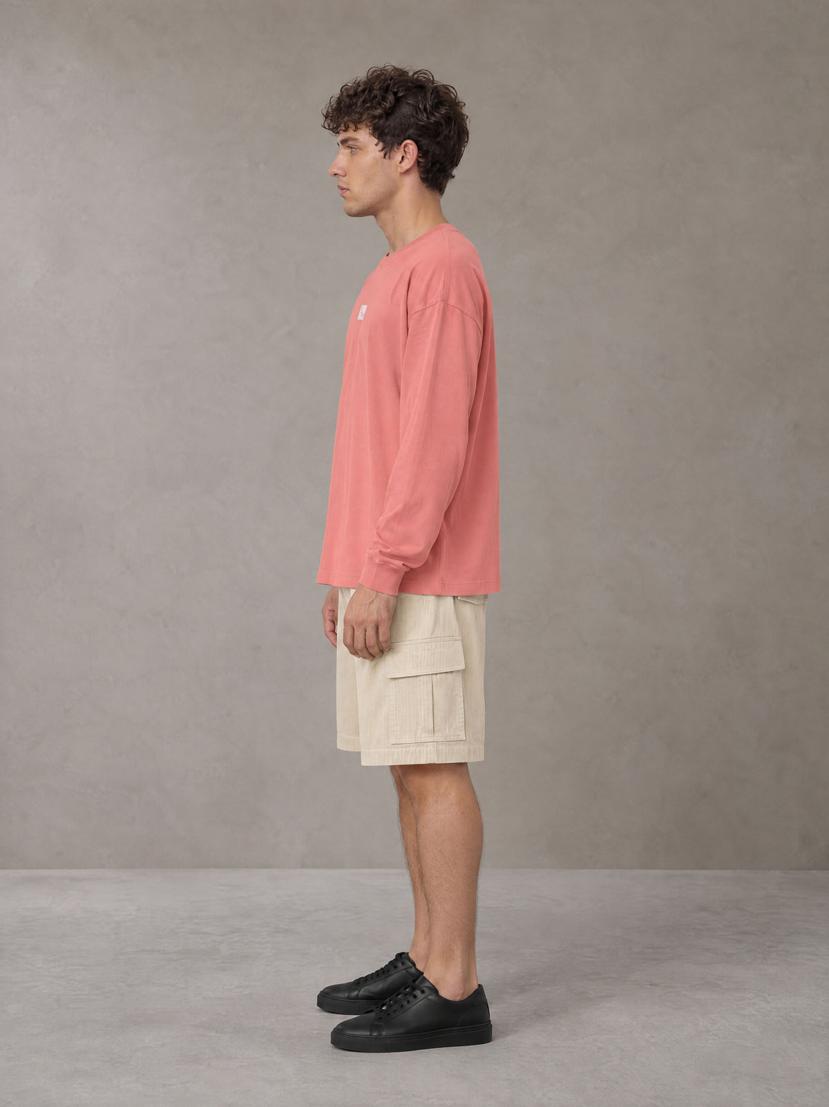 Model wearing SM Sig. Long Sleeve T-shirt in Watermelon Tint, side profile.