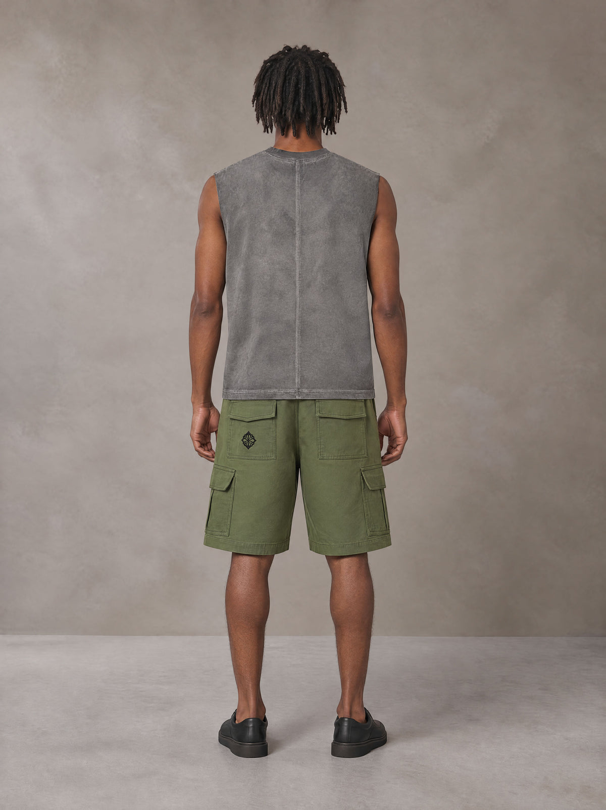 Model wearing SM Sig. Reverse Washed Tank Top in Pure Grey, rear view.