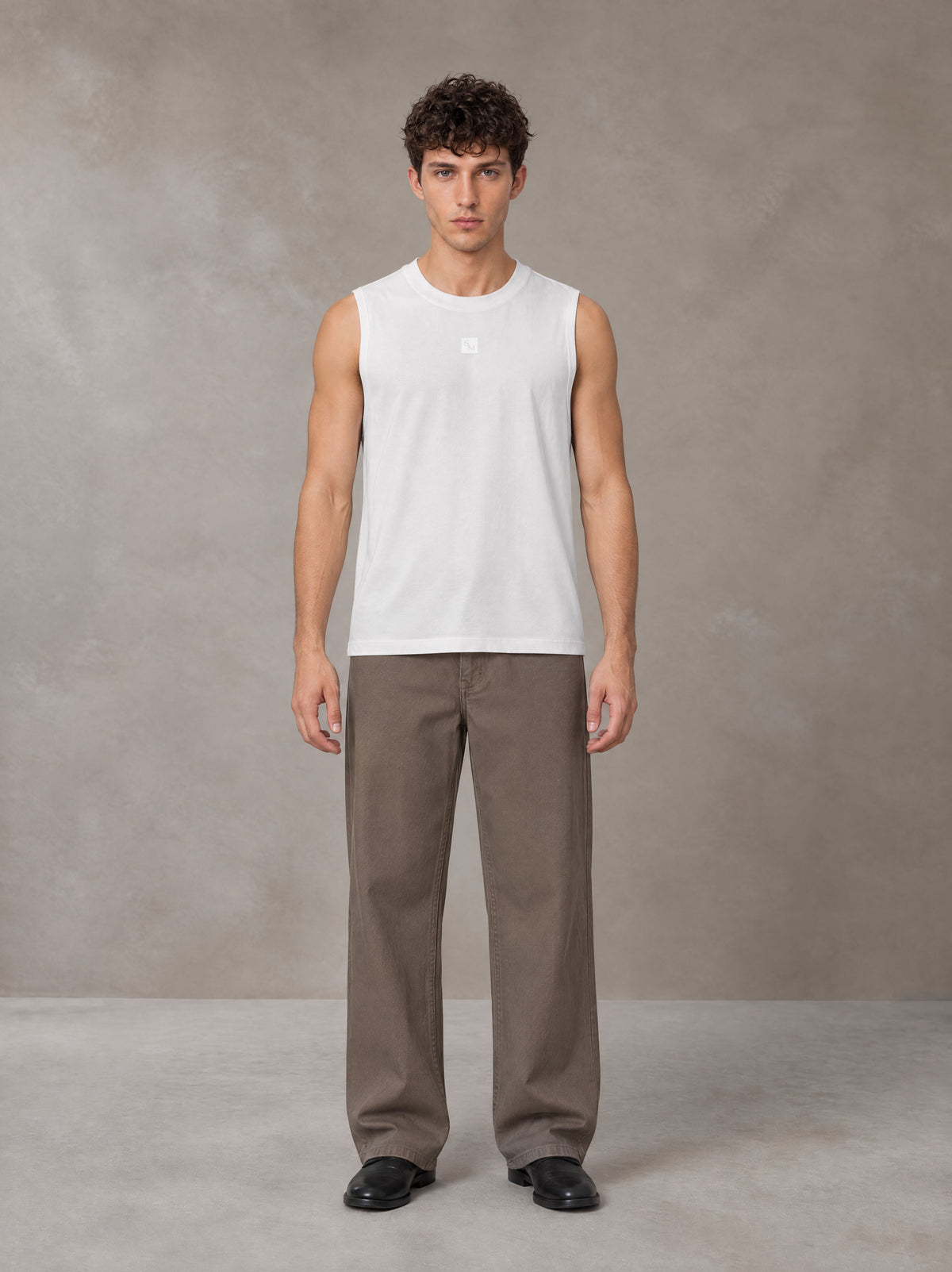 Model wearing SM Sig. Sleeveless Tank Top in Ivory White, front view.