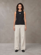Model wearing SM Sig. Sleeveless Tank Top in Midnight Black, front view.