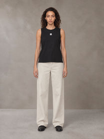Model wearing SM Sig. Sleeveless Tank Top in Midnight Black, front view.