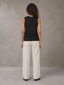 Model wearing SM Sig. Sleeveless Tank Top in Midnight Black, rear view.