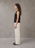 Model wearing SM Sig. Sleeveless Tank Top in Midnight Black, side profile.