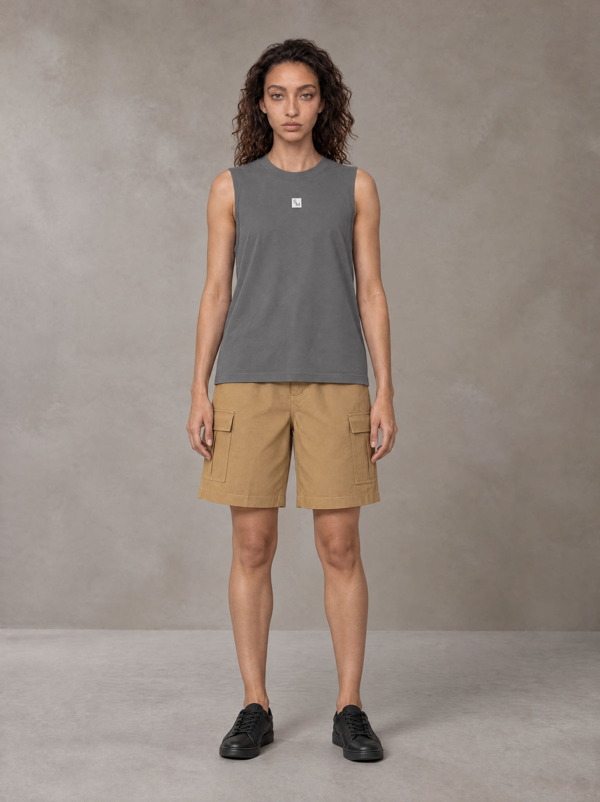 Model wearing SM Sig. Sleeveless Tank Top in Pure Grey, front view.