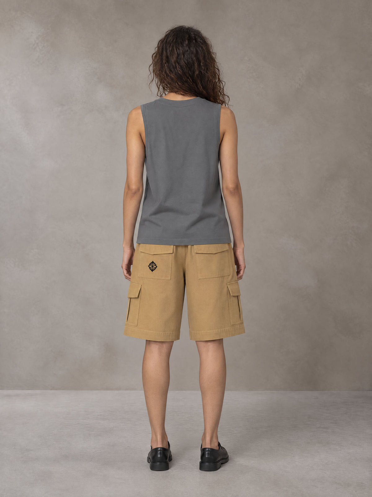Model wearing SM Sig. Sleeveless Tank Top in Pure Grey, rear view.