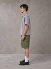 Model wearing SM Sig. Snow Washed Polo T-shirt in Polished Silver, side profile.
