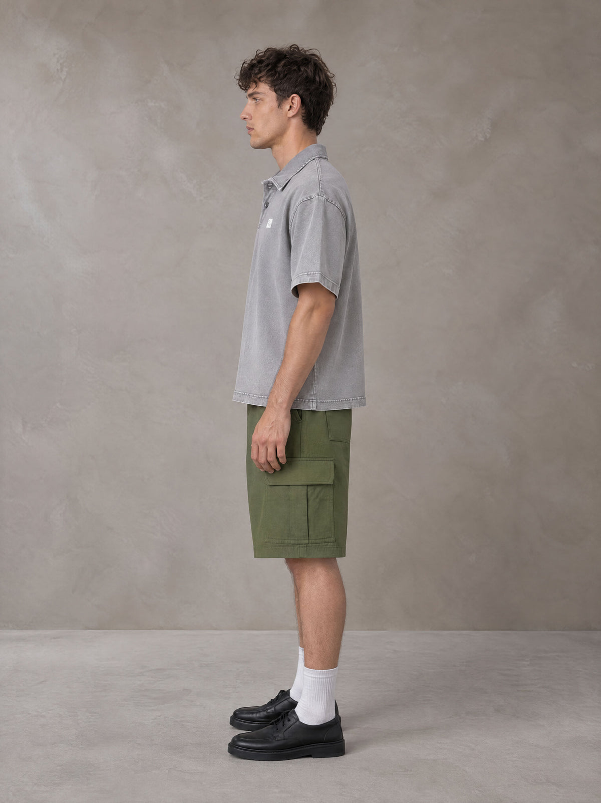 Model wearing SM Sig. Snow Washed Polo T-shirt in Polished Silver, side profile.