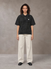 Model wearing SM Sig. Snow Washed Polo T-shirt in Midnight Black, front view.