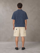 Model wearing SM Sig. Snow Washed Polo T-shirt in Oxford Navy, rear view.