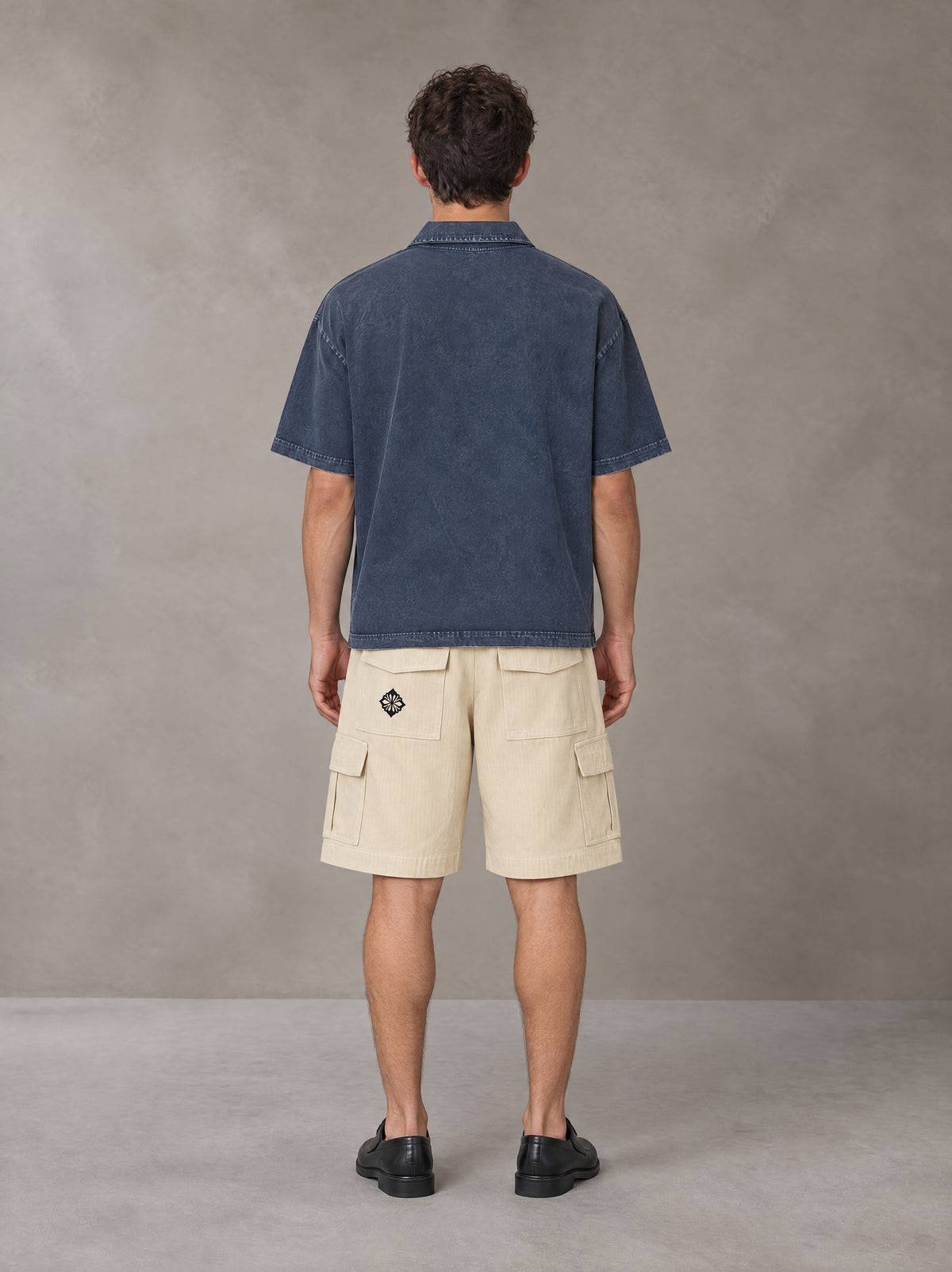 Model wearing SM Sig. Snow Washed Polo T-shirt in Oxford Navy, rear view.