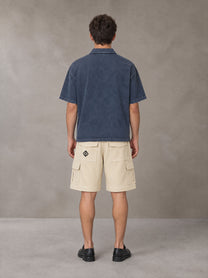 Model wearing SM Sig. Snow Washed Polo T-shirt in Oxford Navy, rear view.