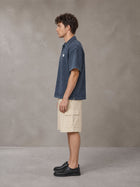 Model wearing SM Sig. Snow Washed Polo T-shirt in Oxford Navy, side profile.