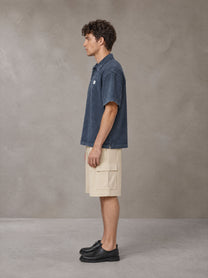 Model wearing SM Sig. Snow Washed Polo T-shirt in Oxford Navy, side profile.