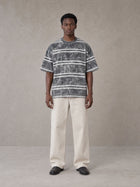 Model wearing SM Sig. Snow Washed Striped T-shirt in Pure Grey, front view.