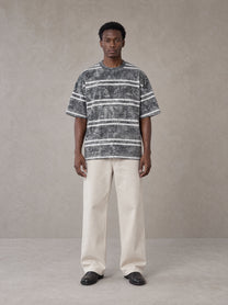 Model wearing SM Sig. Snow Washed Striped T-shirt in Pure Grey, front view.
