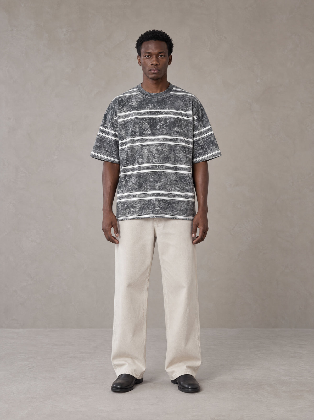 Model wearing SM Sig. Snow Washed Striped T-shirt in Pure Grey, front view.