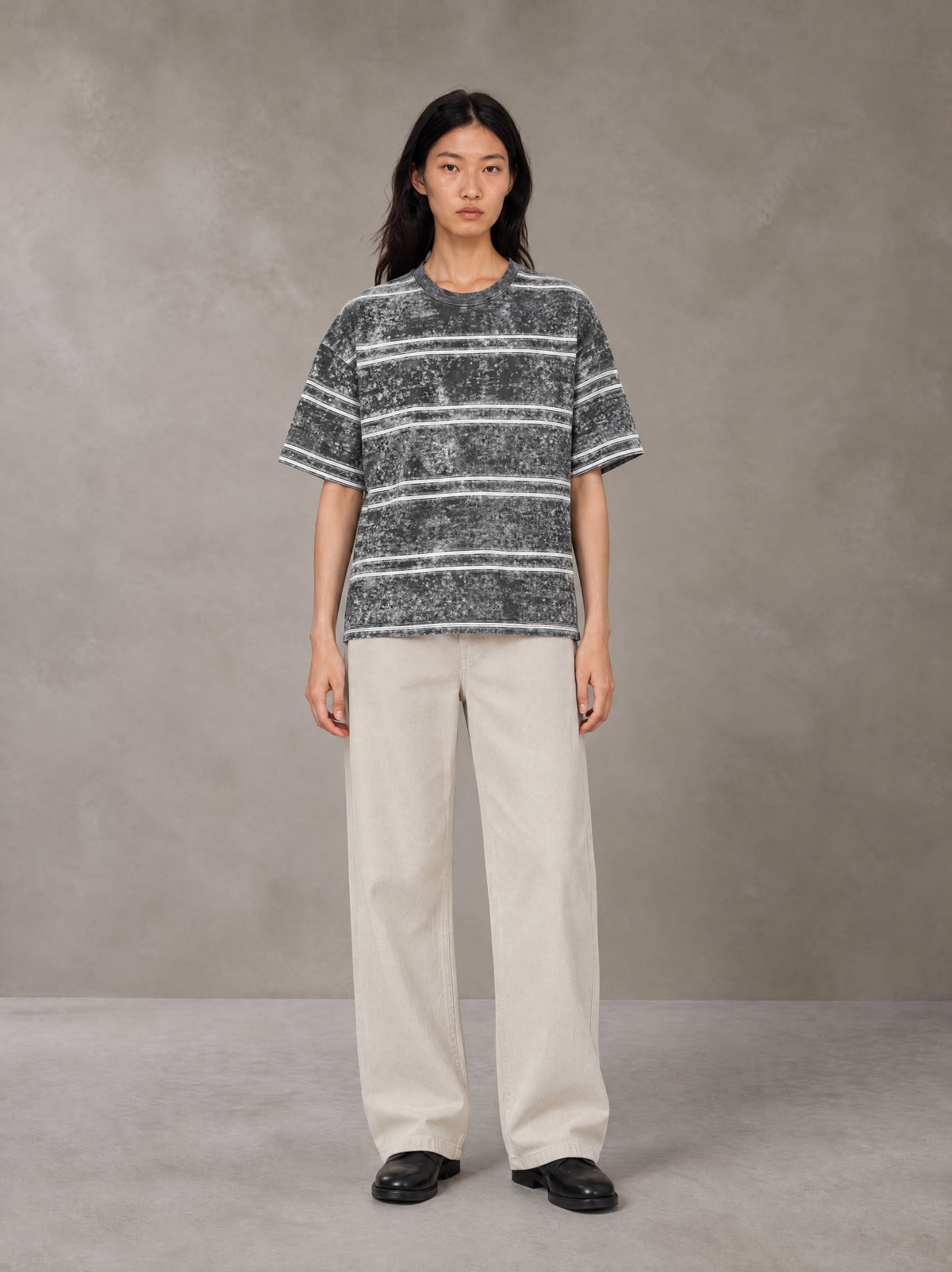Model wearing SM Sig. Snow Washed Striped T-shirt in Pure Grey, front view.