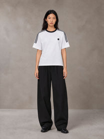 Model wearing SM Sig. Striped T-shirt in Lucent White, front view.
