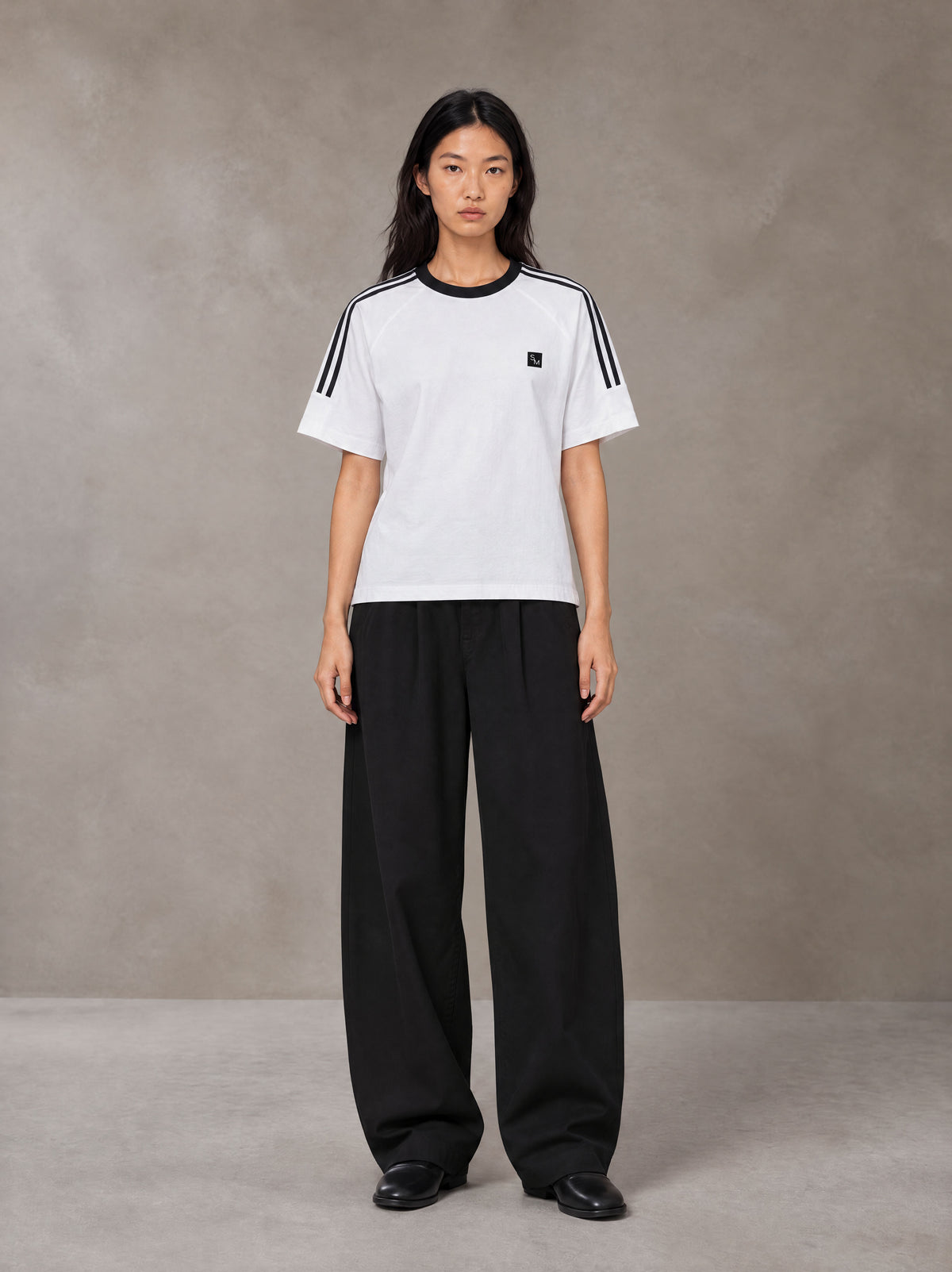 Model wearing SM Sig. Striped T-shirt in Lucent White, front view.