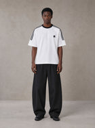 Model wearing SM Sig. Striped T-shirt in Lucent White, front view.