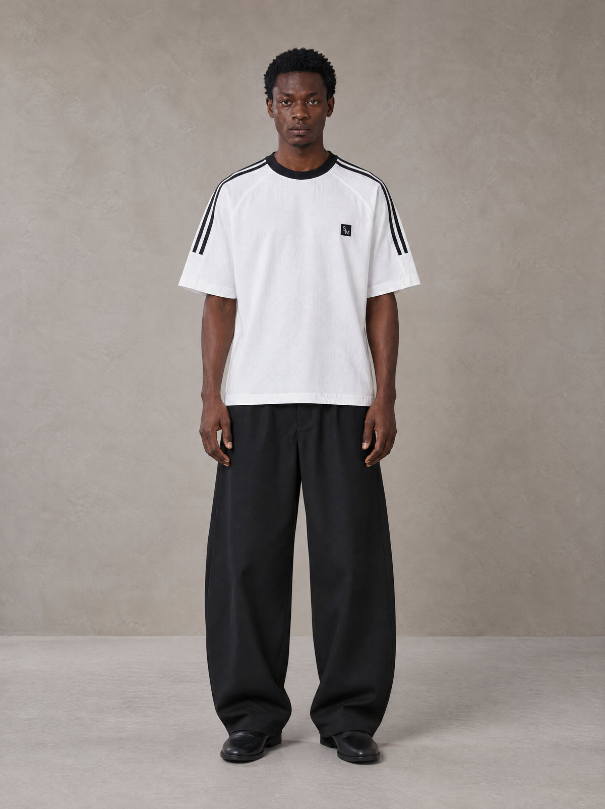 Model wearing SM Sig. Striped T-shirt in Lucent White, front view.